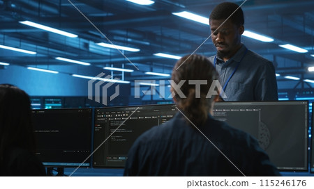 Supervisor in server hub workplace managing diverse team of developers looking for equipment software misconfigurations. Manager coordinating professionals mending data center bugs 115246176