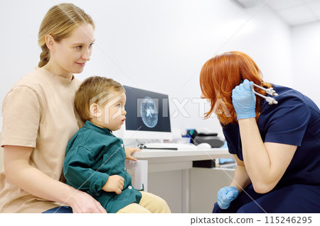 Toddler boy with his mom are at appointment with a pediatric neurologist. Toddler boy with his mom are at appointment with a pediatric neurologist. 115246295