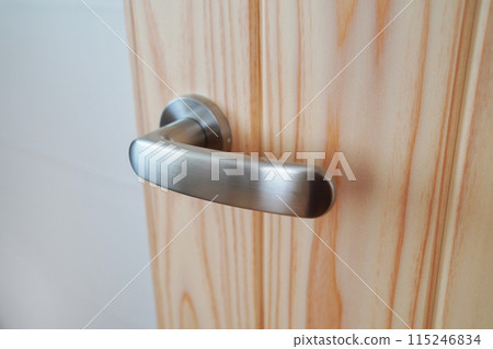 Wooden door with metal doorknob Wooden door with metal doorknob 115246834