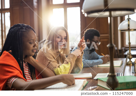 Group of students studying in the library together Group of students studying in the library together 115247000