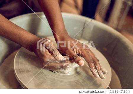 Close up of hands on a pottery wheel Close up of hands on a pottery wheel 115247104