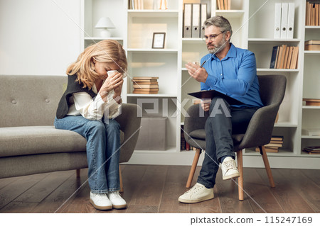 Man psychologist listening attentively to his patient's confession offering advice and counseling Man psychologist listening attentively to his patient's confession offering advice and counseling 115247169