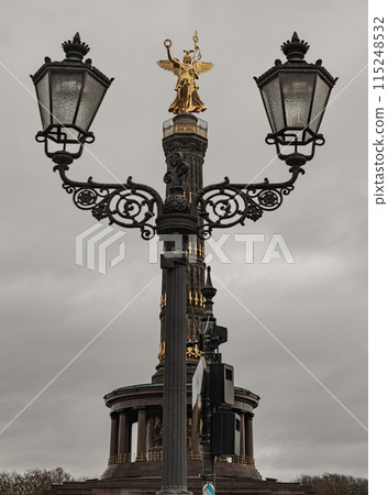 The victory column with historical street lamp in foreground. The victory column with historical street lamp in foreground. 115248532