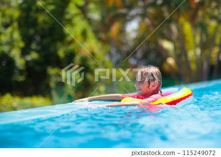 Child in swimming pool on toy ring. Kids swim. Child in swimming pool on toy ring. Kids swim. 115249072