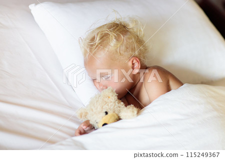 Baby boy sleeping in white bed Baby boy sleeping in white bed 115249367