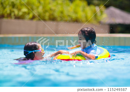 Child in swimming pool on toy ring. Kids swim. Child in swimming pool on toy ring. Kids swim. 115249387