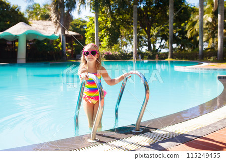 Child in swimming pool with ball. Kids swim. Child in swimming pool with ball. Kids swim. 115249455