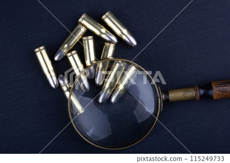 cartridges with a detective's magnifying glass on a black 115249733