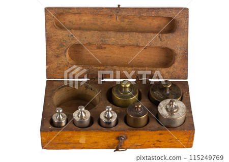 Vintage wooden box with scale weights set on white Vintage wooden box with scale weights set on white 115249769