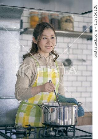 Young woman cooking in the kitchen 115250126