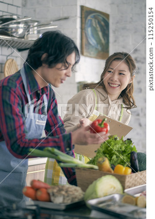 Young couple standing in the kitchen Young couple standing in the kitchen 115250154