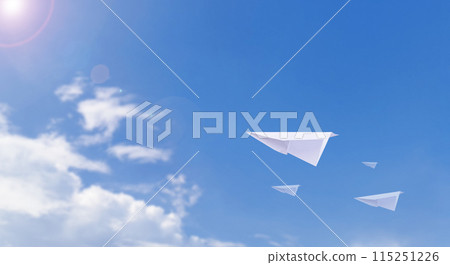 A paper airplane is flying in the beautiful clear sky. 115251226