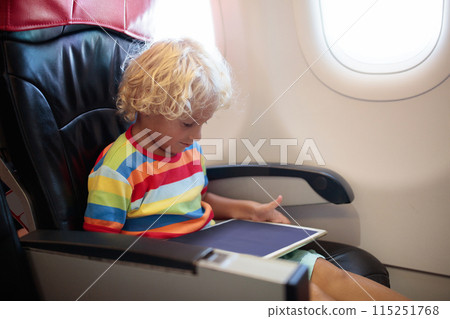 Child flying in airplane. Flight with kids. Child flying in airplane. Flight with kids. 115251768