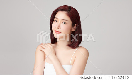 Beautiful young asian woman with clean fresh skin on grey background, Face care, Facial treatment, Cosmetology, beauty and spa, Asian women portrait. 115252410