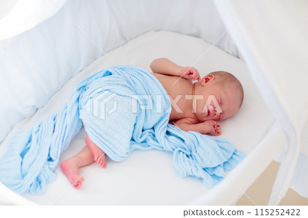 Little baby on white bed Little baby on white bed 115252422