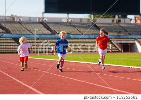 Child running in stadium. Kids run. Healthy sport. 115252562