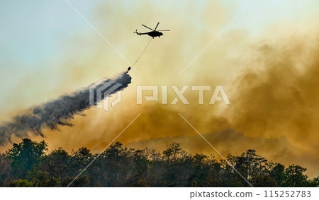 Fire fighting helicopter carry water bucket to extinguish the forest fire. Fire fighting helicopter carry water bucket to extinguish the forest fire. 115252783