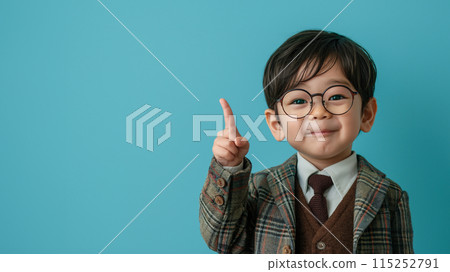 Little boy wearing glasses with index finger up on blue background "AI generated image" 115252791