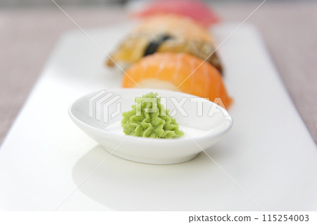 box of sushi and rolls with chopsticks, ginger, wassabi and soy sauce. Food delivery to the home during the coronavirus, food in boxes, bags and disposable food containers. Stay indoors 115254003