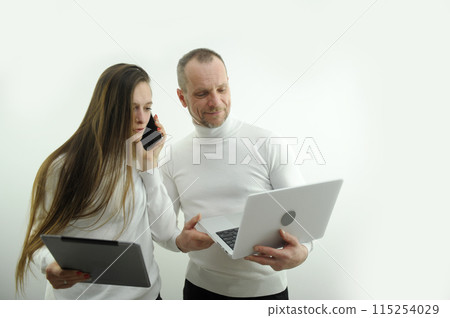 Helpful male boss mentor coach teacher explaining new online project to young female worker student intern, focused leader executive manager training student instructing trainee pointing 115254029