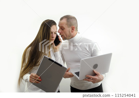 laptop-tablet phone call figuring out some kind of trouble talking on phone man and woma listening white sweaters on a white background online delivery study online lessons long hair teacher student 115254041
