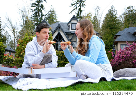 a Happy teen students boy and a girl laughing on a lunch break at school. Selective focus 115254470