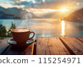 cup of coffee with lake and mountains view on the background at sunrise or sunset 115254971