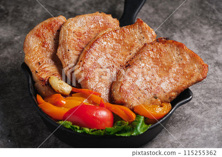 Close-up Pork Sirloin Steak with Fresh salad vegetables 115255362