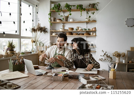 Mature man and woman sculpting clay while watching online video course Mature man and woman sculpting clay while watching online video course 115255620
