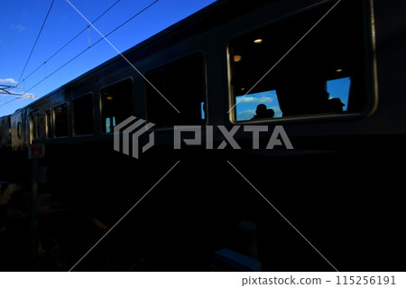 Silhouette of people enjoying a trip on a tourist train 115256191