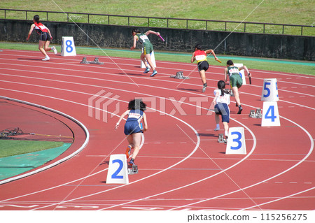 Start of the women's 400m relay at the track and field meet Start of the women's 400m relay at the track and field meet 115256275