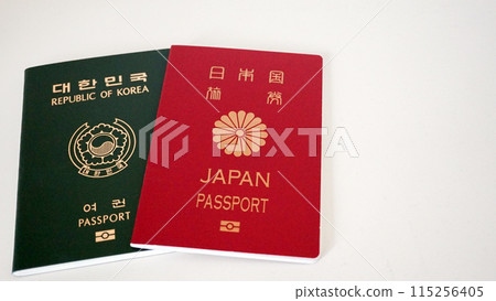 Japanese passport and Korean passport on white background Japanese passport and Korean passport on white background 115256405