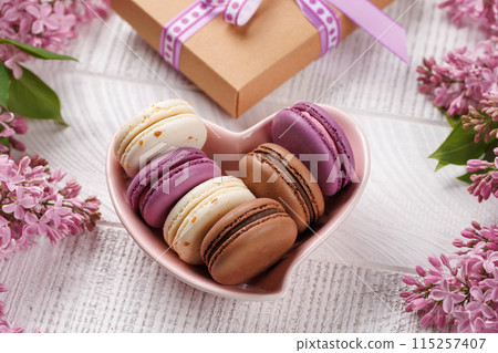Colorful macaroons, arranged in a delightful display of vibrant hues Colorful macaroons, arranged in a delightful display of vibrant hues 115257407