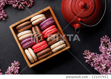 Colorful macaroons, arranged in a delightful display of vibrant hues Colorful macaroons, arranged in a delightful display of vibrant hues 115257411