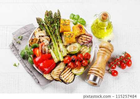 Assorted grilled vegetables on a plate, showcasing a colorful and healthy meal Assorted grilled vegetables on a plate, showcasing a colorful and healthy meal 115257484