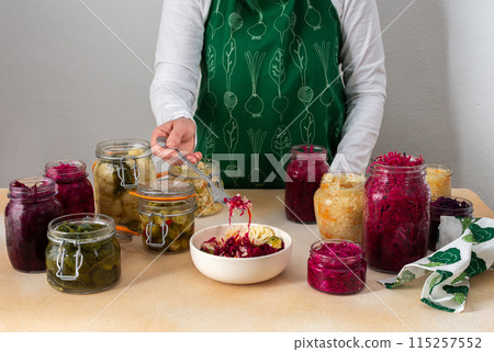Woman fermenting fresh vegetables 115257552