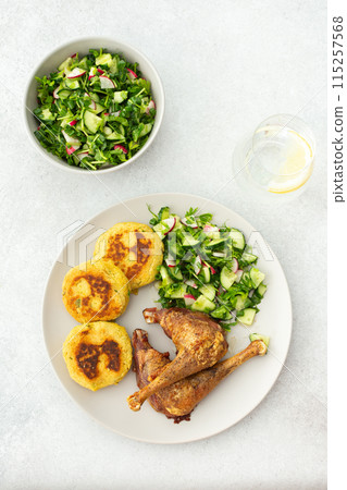Chickpea cutlets with mixed salad with cucumbers and radishes, baked farm chicken legs 115257568