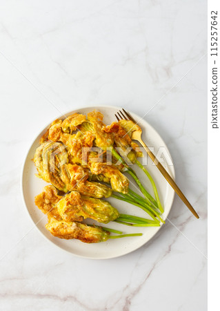 Zucchini flowers in batter 115257642