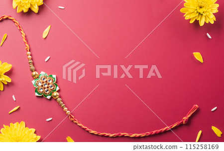 Raksha Bandhan, Indian festival with beautiful Rakhi, Rice Grains and flower. A traditional Indian wrist band which is a symbol of love between Sisters and Brothers 115258169