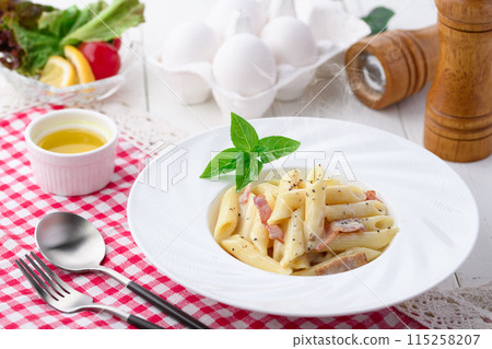 Penne Carbonara (finished with fresh cream and Parmesan) with a rich egg flavor 115258207