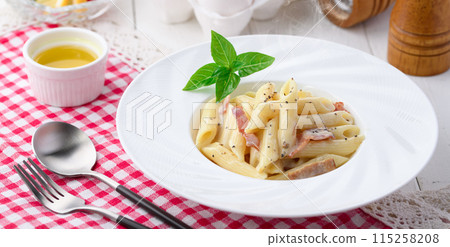 Penne Carbonara (finished with fresh cream and Parmesan) with a rich egg flavor 115258208