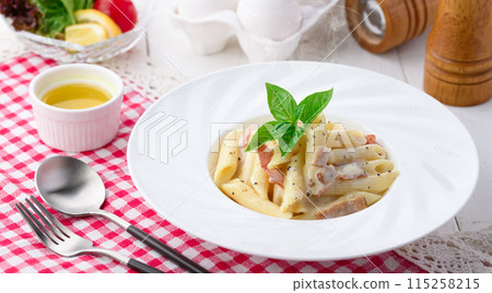 Penne Carbonara (finished with fresh cream and Parmesan) with a rich egg flavor Penne Carbonara (finished with fresh cream and Parmesan) with a rich egg flavor 115258215