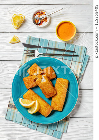 crispy baked battered pollock fillet on a plate 115258405