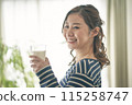 A young lady drinking milk 115258747