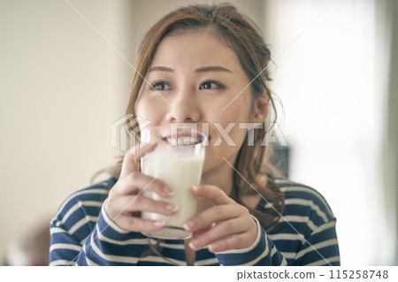 一位年輕的女士喝牛奶 一位年輕的女士喝牛奶 115258748