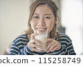A young lady drinking milk 115258749