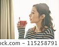 A young woman drinking vegetable juice 115258791