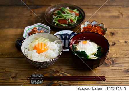 Raw egg on rice set meal, mentaiko, pickles, carrot stir-fry, mizuna and salmon salad Raw egg on rice set meal, mentaiko, pickles, carrot stir-fry, mizuna and salmon salad 115259843