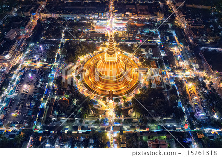 Majestic golden pagoda of Phra Pathom Chedi glowing among the festival lights around the roundabout road in downtown at Nakhon Pathom 115261318