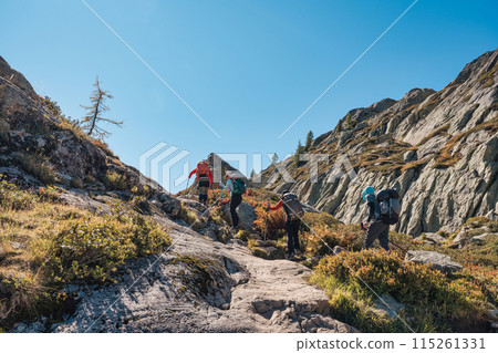 Group of hiker hiking on rocky hill on summit trail amidst the French alps at Chamonix Mont blanc, France 115261331